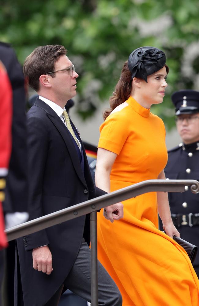 Jack Brooksbank and Princess Eugenie, in orange, arrive for the service. Picture: Getty Images