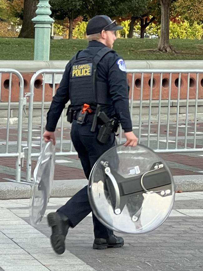 A police officer carrying riot shields at The Capitol in Washington. Picture: Keith Woods.