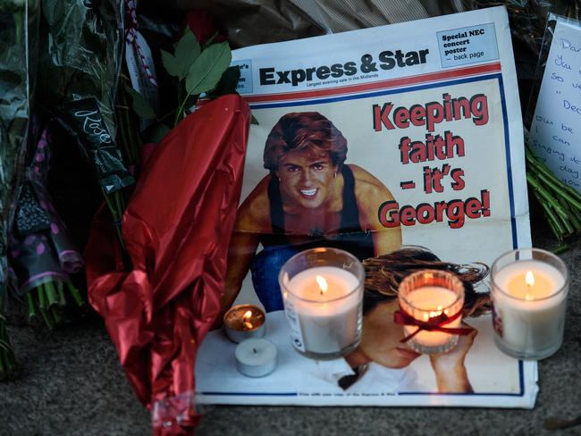 A picture is left with flowers and tributes outside the Oxfordshire home of British pop singer George Michael on December 26, 2016 in Goring, England. Picture: Getty