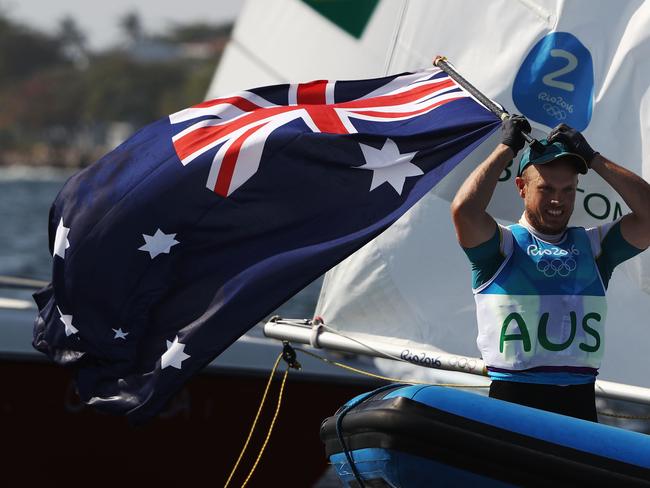 Tom Burton of Australia celebrates winning the gold medal in the Men's Laser class