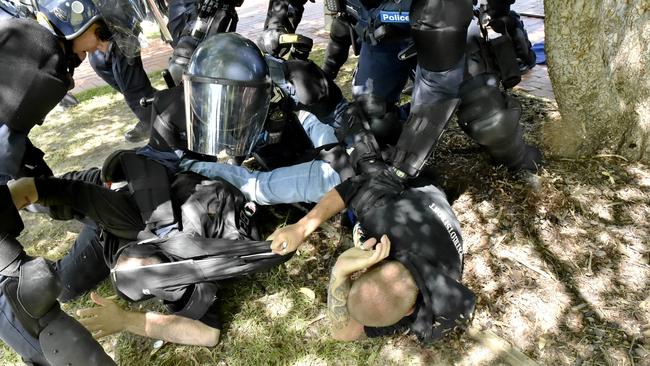 Riot police tackle protesters. Picture: Jason Edwards