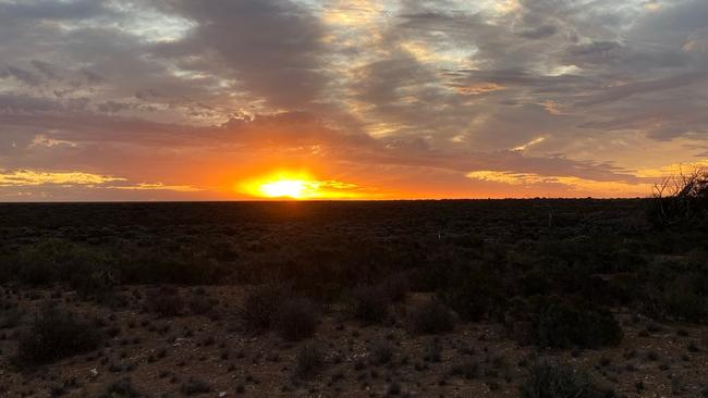 Liam Baker watches the sun go down during his return journey to Melbourne.