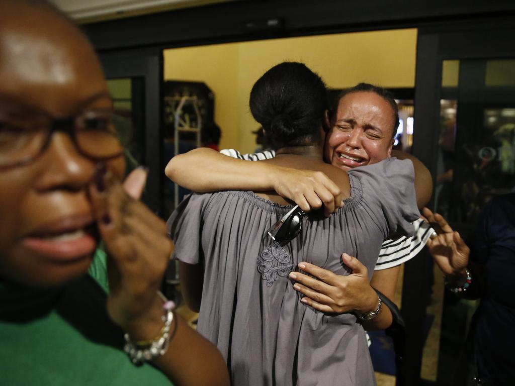 Roshane Eyma, centre, cries as she is greeted by members of her church after being rescued and flown to Nassau from devastated Abaco Island. Picture: Getty Images