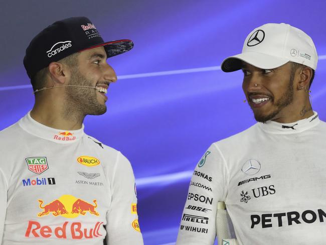 Red Bull driver Daniel Ricciardo of Australia, left, and Mercedes driver Lewis Hamilton of Britain, speak to each other during a press conference after winning the Singapore Formula One Grand Prix on the Marina Bay City Circuit Singapore, Sunday, Sept. 17, 2017. (AP Photo/Yong Teck Lim)