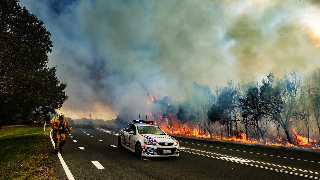 Firefighters on the scene at an out of control bushfire at Peregian Beach, where hundreds of residents were evacuated yet again. Photo Lachie Millard