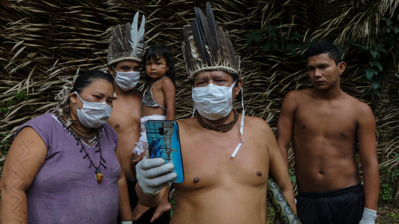 A group including a young child talk on a smart phone with a doctor. Picture: Ricardo Oliveira/AFP