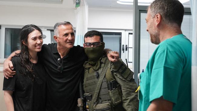 Noa Argamani, her father and one of her rescuers after she was extricated from Hamas captivity in the Gaza Strip. Picture: AFP.