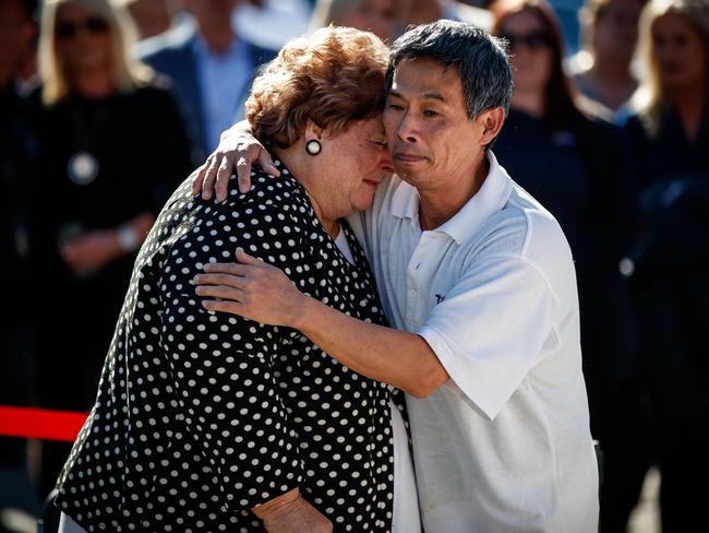 A worker at the bakery comforts Rosemary Milisits during a guard of honour. Picture: Matt Turner