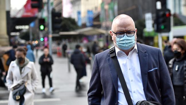 MELBOURNE, AUSTRALIA - NewsWire Photos JULY 13, 2022:  People wear masks outdoors as COVID cases are expected to rise in Melbourne. Picture: NCA NewsWire / Nicki Connolly