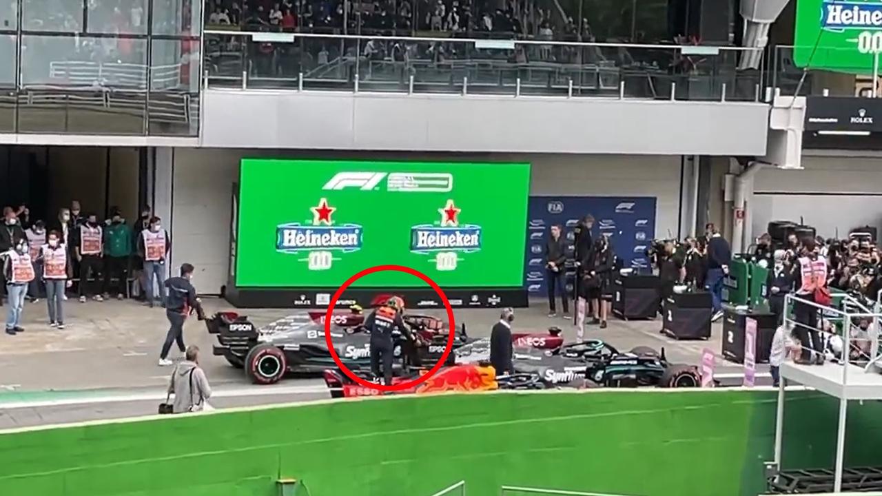 Max Verstappen touches Lewis Hamilton’s wing.