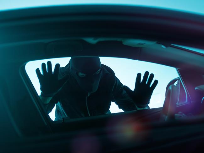 Car Robber Concept Photo. Robber Looking Thru Car Window. Carjacking Theme.