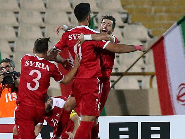 Players celebrate the stoppage time goal.