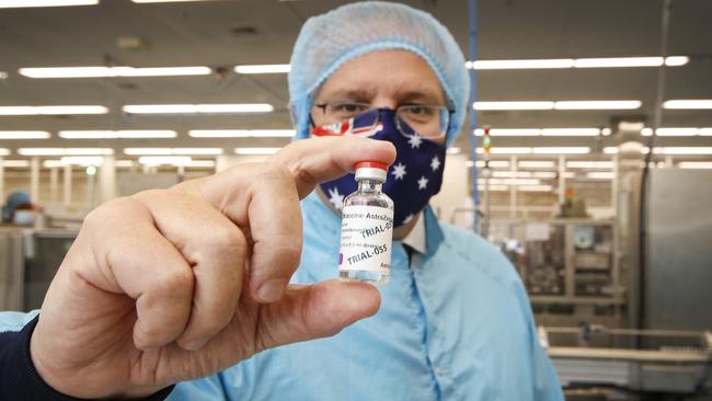 Prime Minister Scott Morrison visit to CSL serum lab to inspect COVID-19 Immunoglobulin being produced in Parkville Melbourne. PM Morrison holds a vial of AstraZeneca vaccine.    Picture: David Caird POOL IMAGES