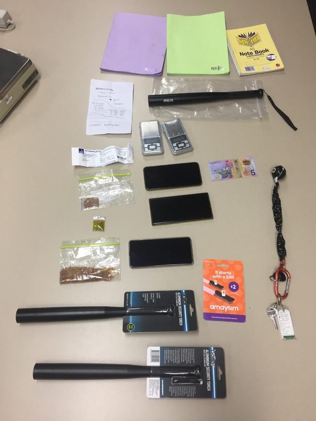 Drugs and items uncovered during a police search in Airlie Beach on Thursday. Police allege more than 1kg of MDMA was uncovered.