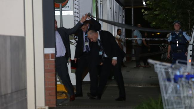 Detectives arrive at the Auburn crime scene after the shooting. Picture: Bill Hearne