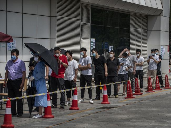 People line up for a nucleic acid test for COVID-19 at a testing centre at a local hospital on in Beijing. Picture: Getty Images