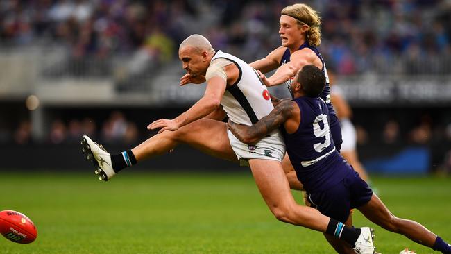 The Power’s Sam Powell-Pepper is tackled by Bradley Hill and Stefan Giro of the Dockers during the Round 17 loss in Perth. Picture: Daniel Carson/AFL Media/Getty Images