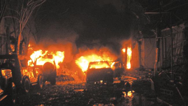 Cars burn outside the Sari Club in Denpasar, Bali, after two bomb blasts at adjacent nightclubs in 2002.
