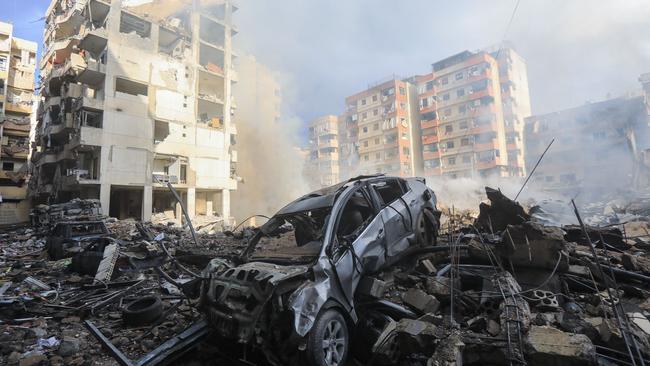 Smoke seeps out from building rubble at the site of an overnight Israeli air strike on the Laylaki neighbourhood in Beirut's southern suburbs on October 1. Picture: AFP