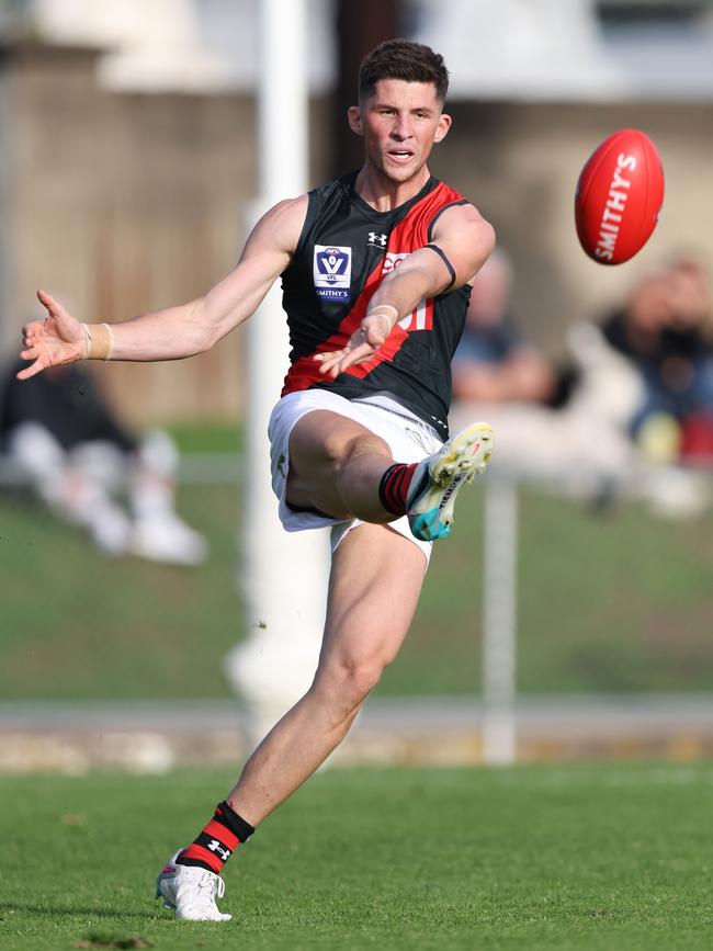 Will Hoare takes a clearing kick for the Bombers. Photo: Rob Lawson/AFL Photos