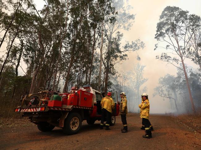 Firefighters battle bushfires in Busbys Flat, northern NSW, Wednesday, October 9, 2019. (AAP Image/Jason O'Brien)