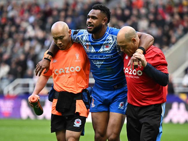 Samoa's Hamiso Tabuai-Fidow is helped to leave the picth following an injury during the 2021 rugby league World Cup men's Round 1 match between England and Samoa at St James' Park in Newcastle upon Tyne in north-east England on October 15, 2022. (Photo by Oli SCARFF / AFP)