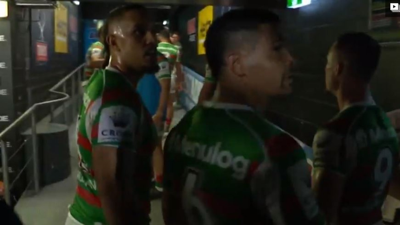 Rabbitohs players leaving the field react after a fan allegedly shouted out a racial slur.