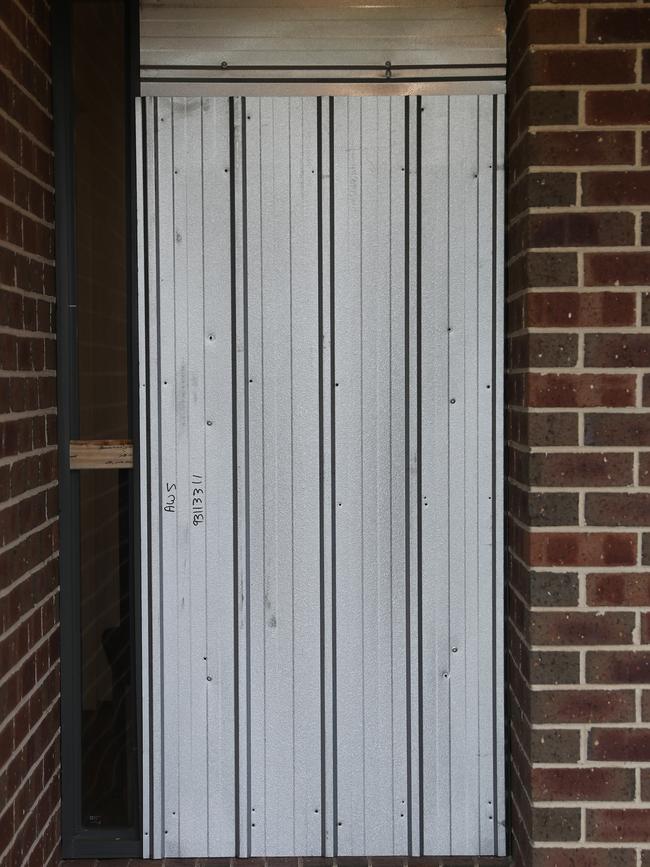 The damaged front door. Picture: David Crosling