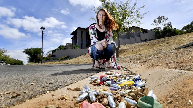 Breakwater Ct resident Laura Stanley with just some of the litter left in the court. Picture: AAP/Sam Wundke