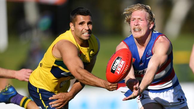 Reigning Central District best and fairest Travis Schiller handballs during a game against Woodville-West Torrens last season. Picture: AAP/Mark Brake