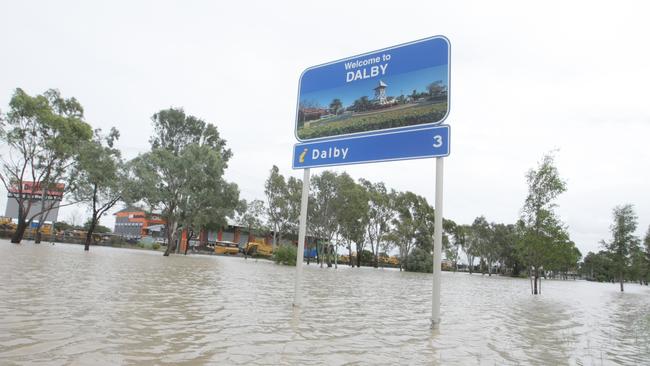 Welcome to Dalby … sign surrounded by flowing flood water at the eastern entry into the township. 29th March 2022. Photo: David Martinelli