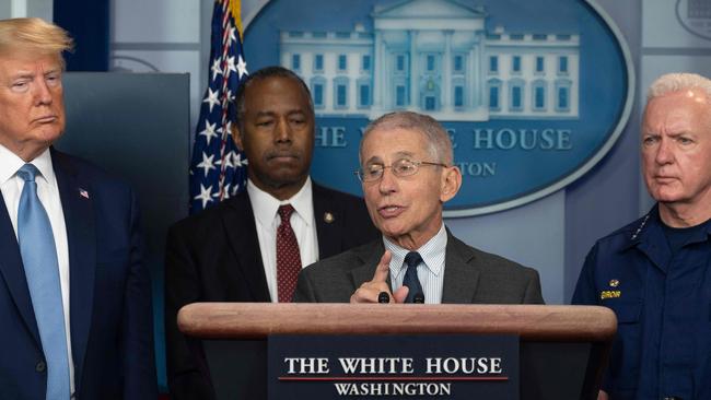 President Donald Trump, who thought COVID-19 was initially a “hoax”, watches National Institute of Allergy and Infectious Diseases Director, Dr. Anthony Fauci, speak during a daily briefing. Picture: Jim Watson/ AFP