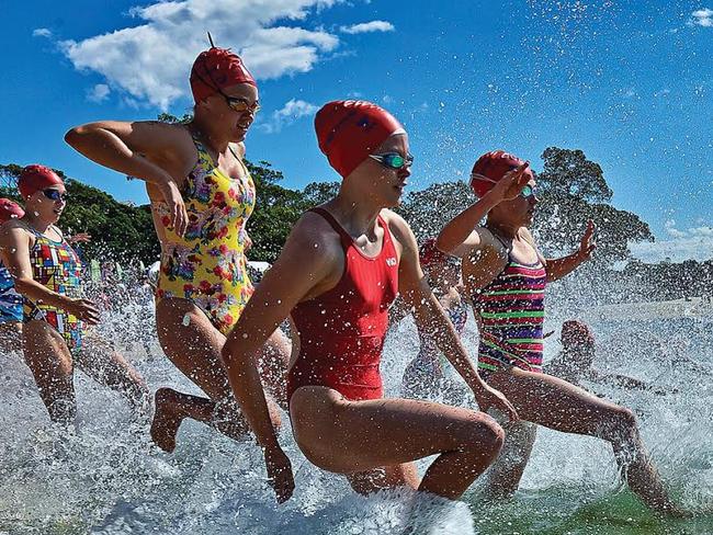 Participants race into the waves during a previous Balmoral Swim cancer fundraiser. Picture: Supplied