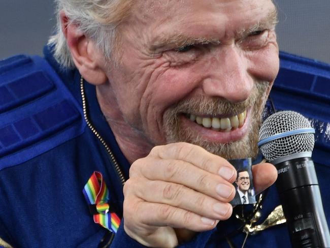 Sir Richard Branson holds up a photo of comedian Stephen Colbert that he brought with him into space, as he speaks after flying into space aboard a Virgin Galactic vessel, a voyage he described as the "experience of a lifetime". Picture: AFP