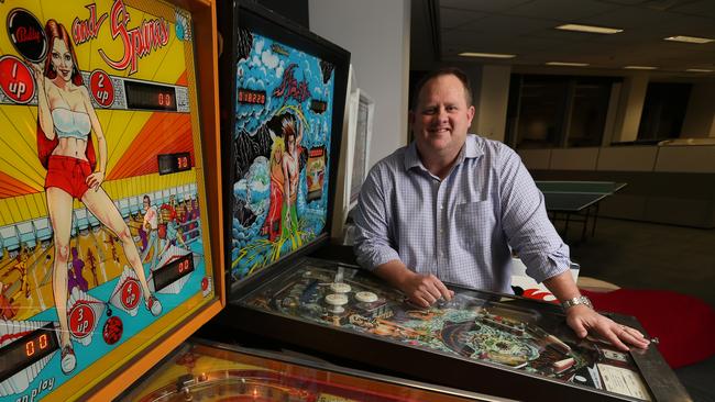 Bevan Slattery founder, chairman and ceo of Superloop, with his cherished pinball machines in his office for staff to use, in the cbd, Brisbane. Bevan paid for the swimmers to have a dedicated jet plane to fly to the Rio Olympics. Lyndon Mechielsen