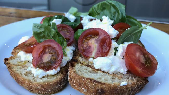 Tomatoes, ricotta and feta on linseed. Picture: Jenifer Jagielski