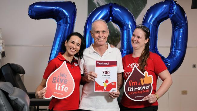 Len Bennett is congratulated on his 700th donation by Lifeblood’s Gwendolyne Camaret and registered nurse Mayer Cook-Tonkin. Picture: Brendan Radke