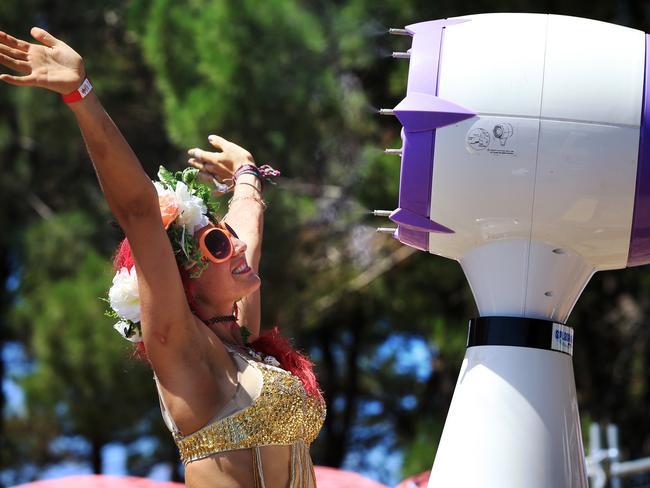 Giant mister machines were employed to help keep the festival goers such as Angela Wannet cool. Picture: Toby Zerna