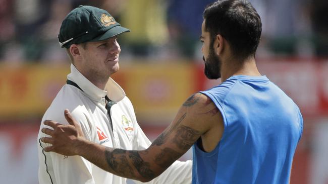 Chief combatants Steve Smith and Virat Kohli shake hands.