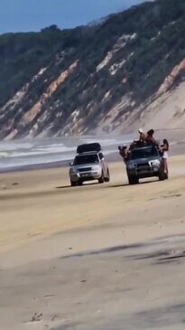 Footage of people hanging onto 4WD at Rainbow Beach