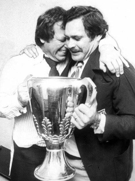 Allen Aylett and Barassi hug with the 1975 premiership cup.