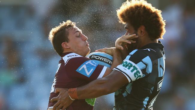 Blake Leary of the Eagles is tackled by Junior Roqica of the Sharks.