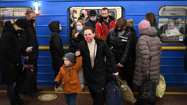 People walk out of a train at a metro station in Kyiv early on February 24. Picture: Daniel Leal/AFP