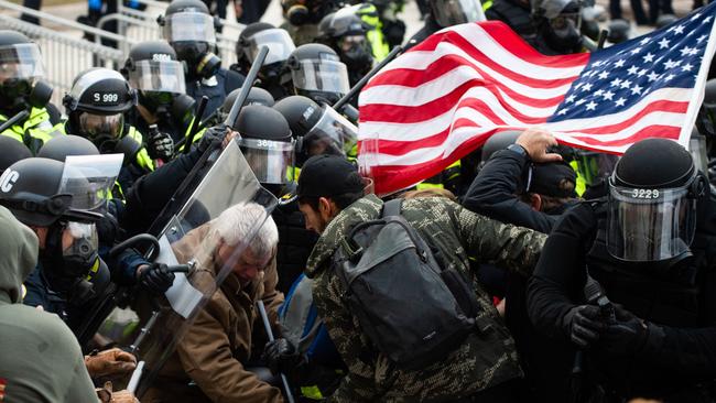 Supporters of US President Donald Trump fight with riot police outside the Capitol building on January 6.