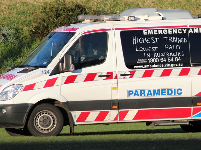 Category:News; Caption:At an under 16s football game in Essendon yesterday an ambulance was called for a player that laid motionless for 15 minutes after a marking contest. When the ambulance arrived most spectators and players were surprised it had been graffiti\'d with slogans relating to pay claims and the salaries of political leaders. (2nd pic); Read the terms and conditions:YesWEBSITE READER PICTURE HWTWayne Brasher , changingpockets@gmail.com, 0425892371,