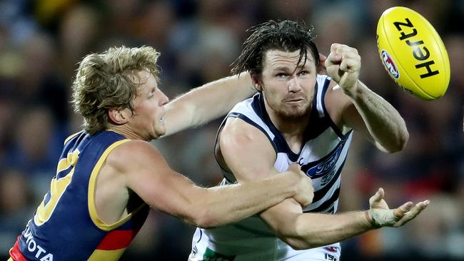 Rory Sloane and Patrick Dangerfield comtest for the ball.