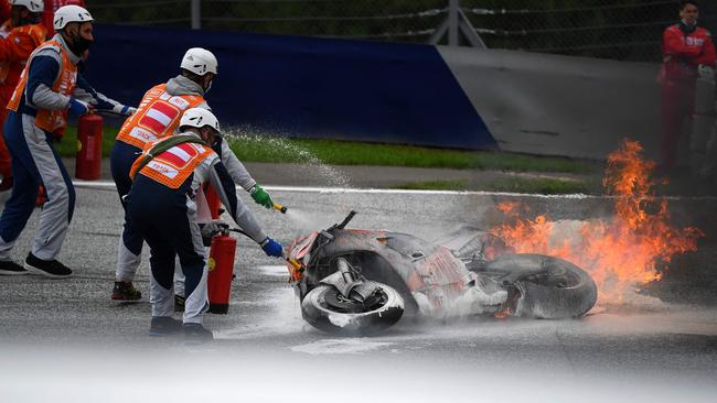 Track marshals put out the flames. Fortunately, both riders were able to walk away. Picture: AFP