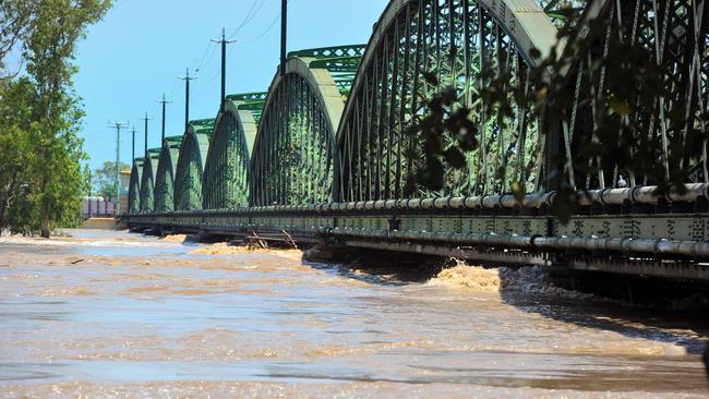 Bundaberg railway bridge as flood waters rise.Photo: Max Fleet