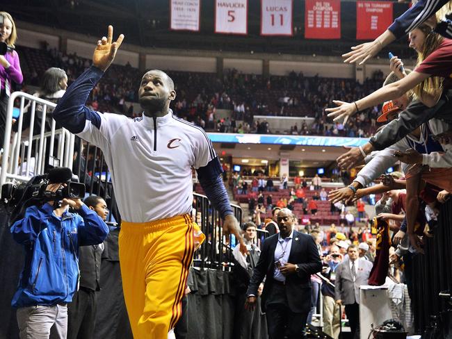 LeBron James #23 of the Cleveland Cavaliers waves to the crowd as he leaves the court following the Cavaliers' 107-98 victory over the Chicago Bulls.