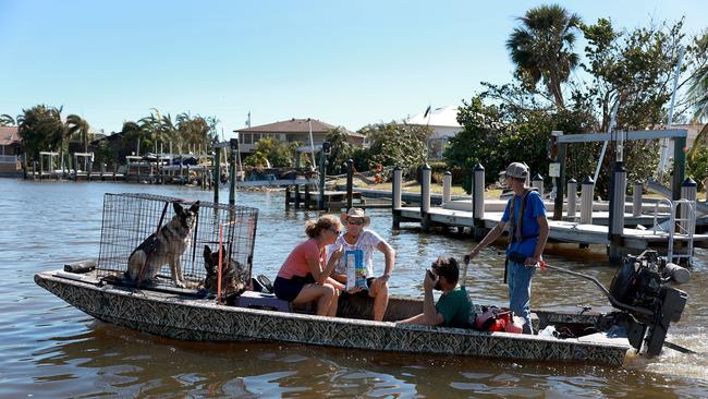 Blake McConnell, with the Cajun navy, uses a john boat to evacuate Jon Guenther and Maureen Guenther from their home after Hurricane Ian passed through. Picture: AFP